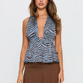 Woman wearing a blue and black zebra print top